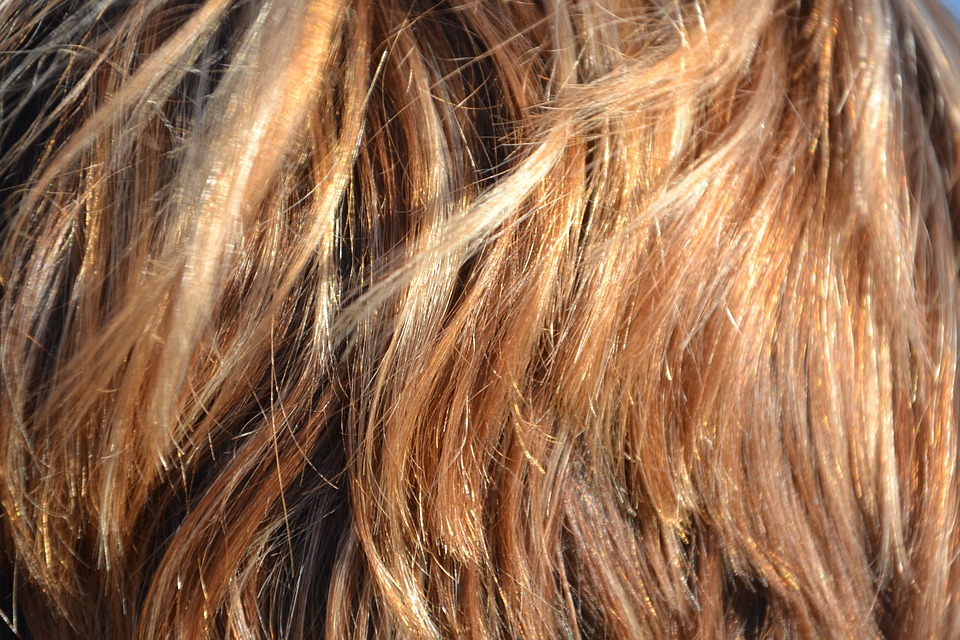 A close-up of overlapping strands of brown hair